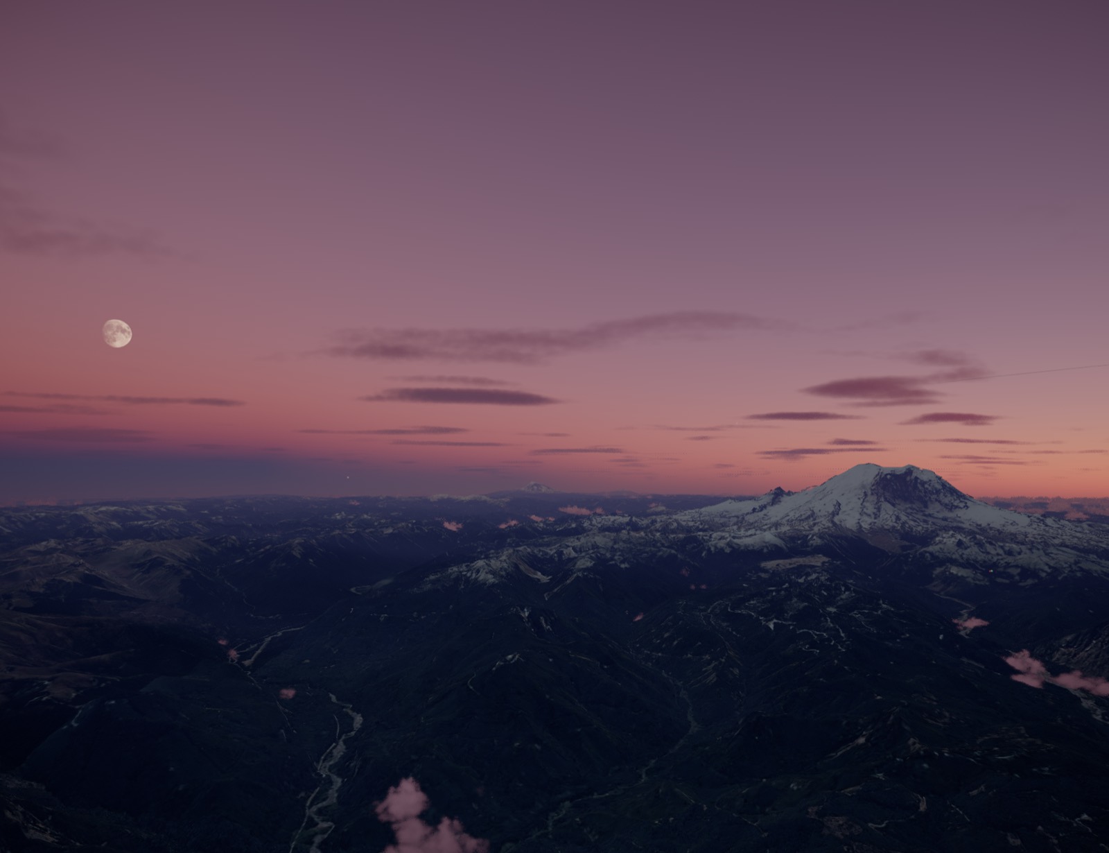 A snow-covered peak at dusk, with the moon already up
