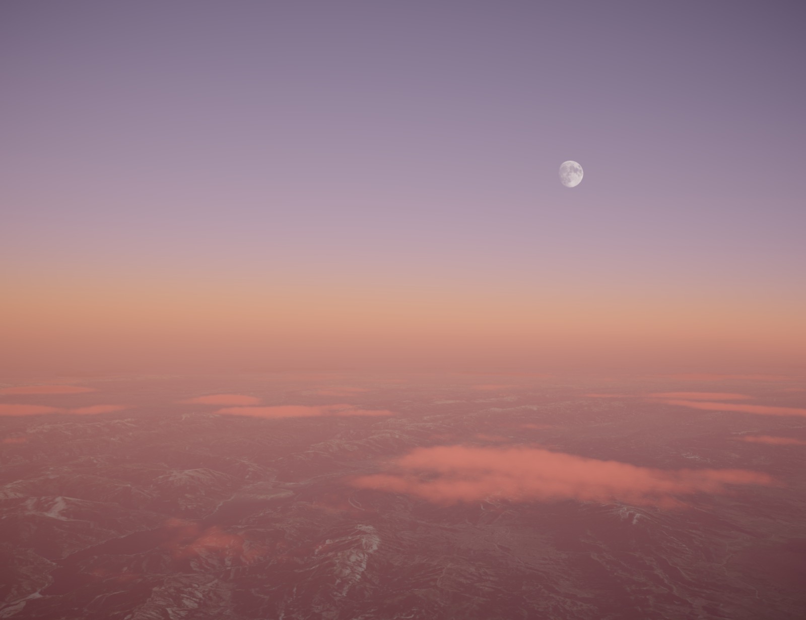 The moon over high desert at last light