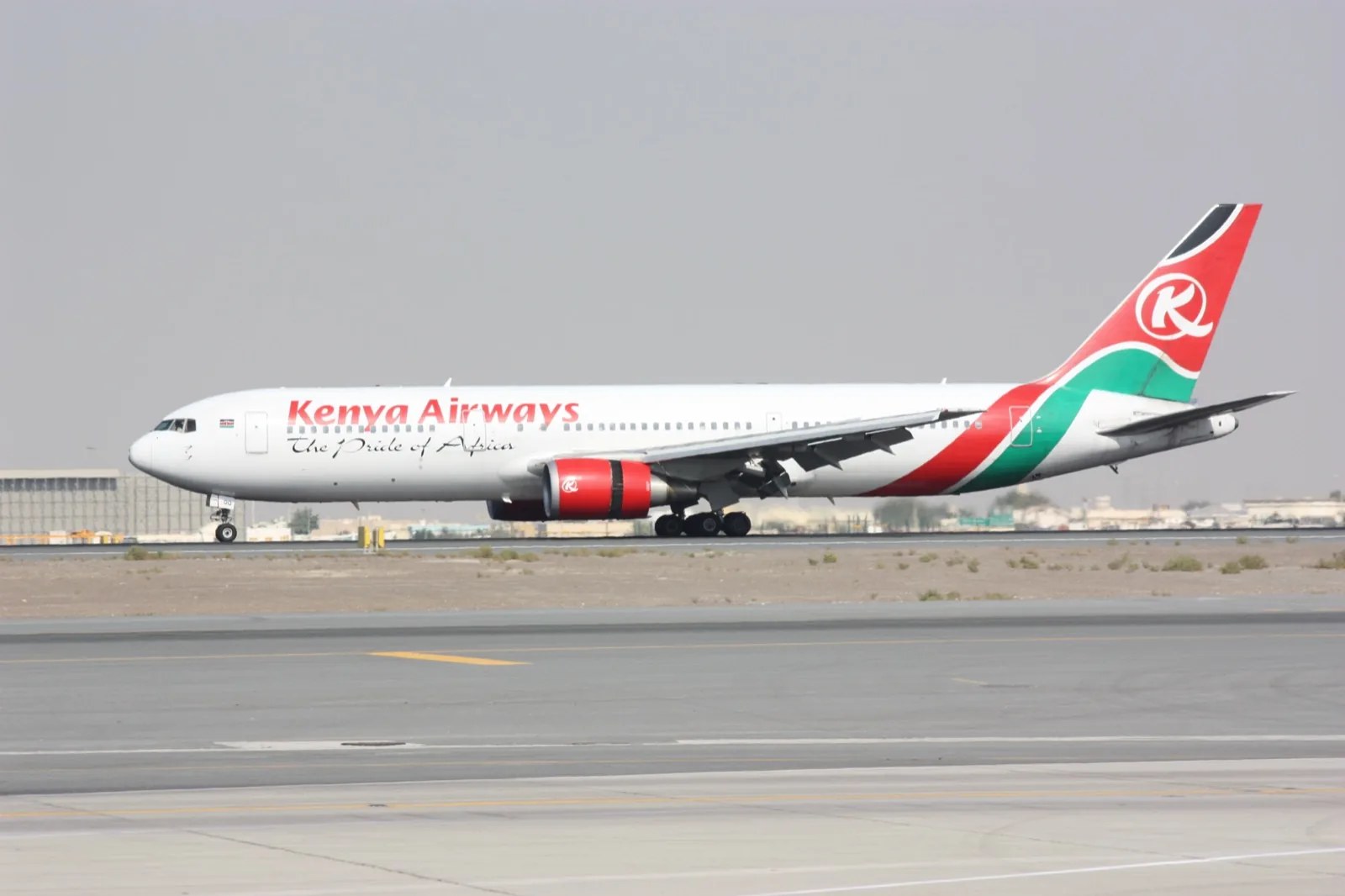 Kenya Airways Boeing 767-300ER 5Y-KQQ, white with a red engine and a red, green and black tail, on the runway at Dubai