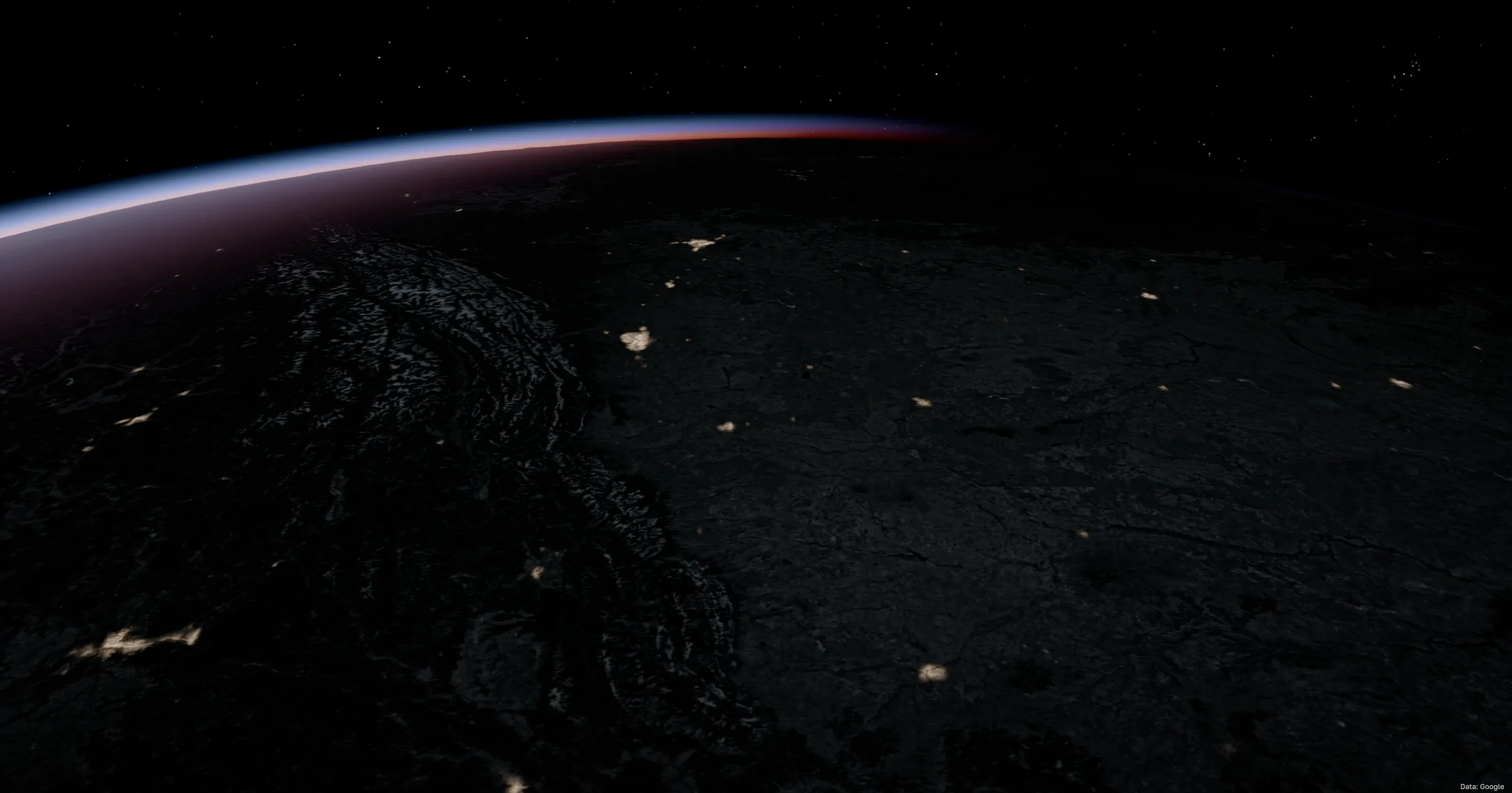 Earth's curve at night from orbit — a thin blue and red band of atmosphere, scattered city lights, and stars above